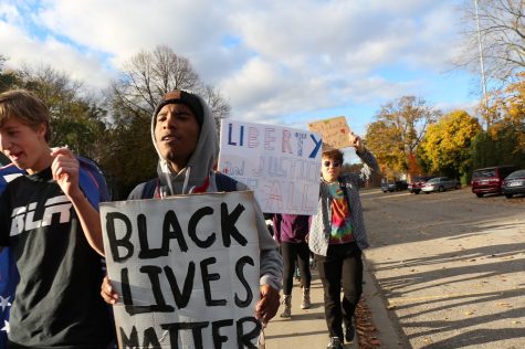 Rockim Williamson '18 holds a "Black lives matter" sign during the unity rally. 