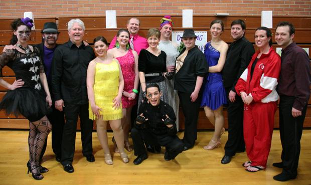 Photo by CARRIE HALLIBURTON | Sophomore Class Adviser.  Dancing with the South Stars gather together with their professional dance partners to take a group photo before the show