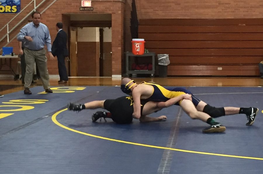 Earl Allard 16 goes to the mat with his opponent. Photo courtesy of Sydney Stann 14