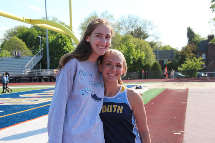 Emma Edwards 17 with runner Hadley Diamond 16.  Both girls play roles in the track and cross country teams. 