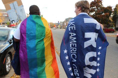 Student wrapped in pride flag and student wrapped in Trump flag walk side by side. All photos by Riley Lynch '18