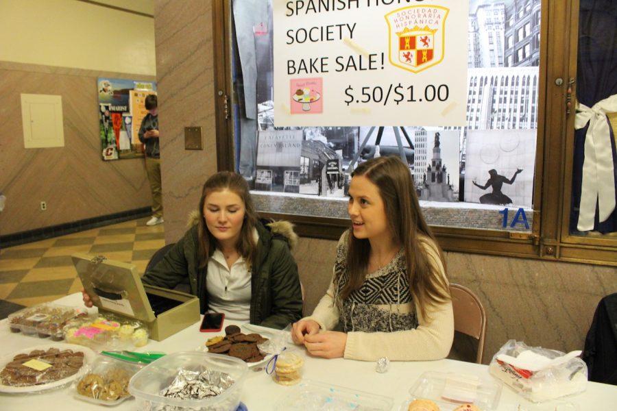 Claire Hubbell, and Mary Grace OShea, both 17, helping out with the Spanish Honor Societys bake sale last week.