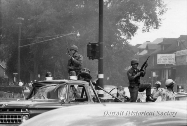 Armed National Guardsmen patrol the city in the 67 Detroit riots. 