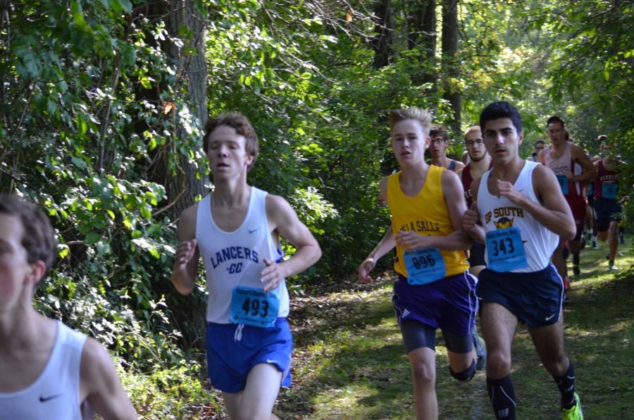 Isaac Kado (far right) is a captain and one of the fastest runners on the boys cross country team. Here he is shown racing at the Algonac Muskrat Classic, where he finished seventh for the Blue Devils.