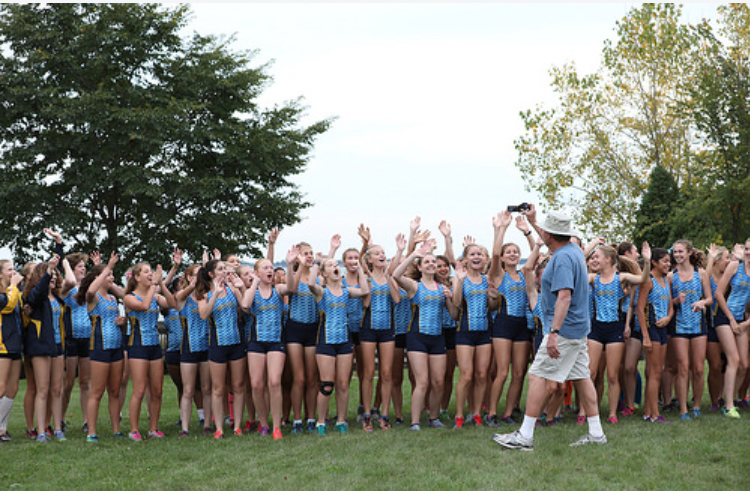Zaranek believes that creating a positive environment will help a team reach its max potential. Here he is shown encouraging the girls cross country team and making them excited for one of their meets.