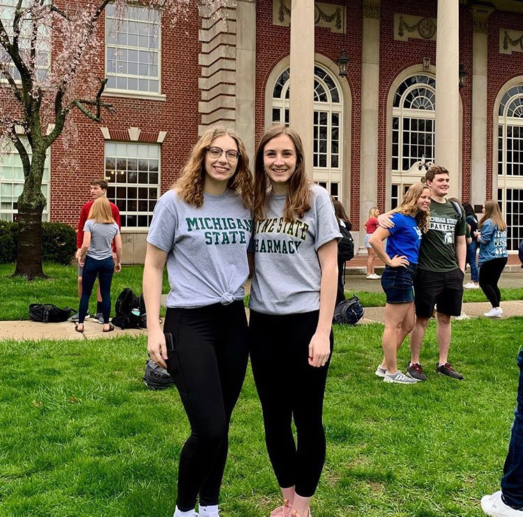 Emma Kniivila 19 poses on the front lawn for decision day with Mary Malbouef 19. Kniivila will be studying organic chemistry. 
Photo courtesy of Emma Kniivila 19. 