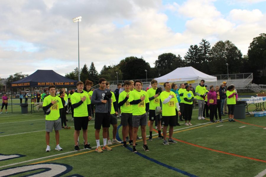 Representatives from almost every Varsity sports team at South came out on Saturday morning in support of GPS Athletics. Here, the Blue Devil Hockey team stands for the National Anthem moments before the start of the first race of the day: the 10k. 