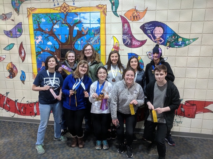 The Science Olympiad team stands with their medals and ribbons after the Perry Invitational on Jan. 12, 2019. Their goal this year is to make it states again this year. Photo courtesy of Tiffany Nikai 19.