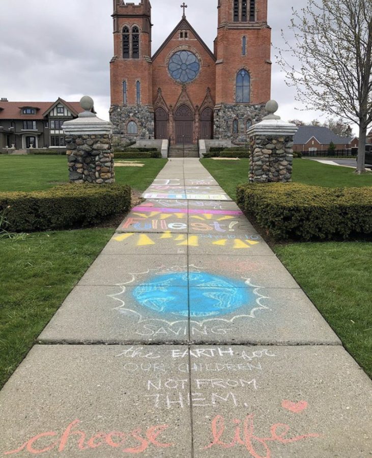 St. Paul on the Lake Catholic Church pictured with the chalk art of Maddy Campbell 20. 