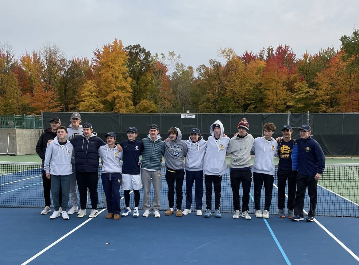 Conner Stafford (featured on the left in a navy shirt and white shorts) poses for a photo with his team after winning gold in first singles in the division two state tournament at Midland Tennis Center on Oct. 15.