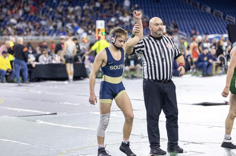 The referee lifts Wyatt Hepners 25 arm in victory after defeating his opponent in an intense match. 