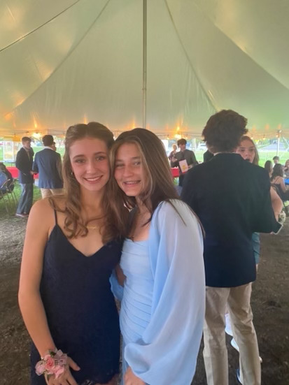 Maddie Zann ’24 and Monroe DeSmyster ‘25 pose under a tent at homecoming.

