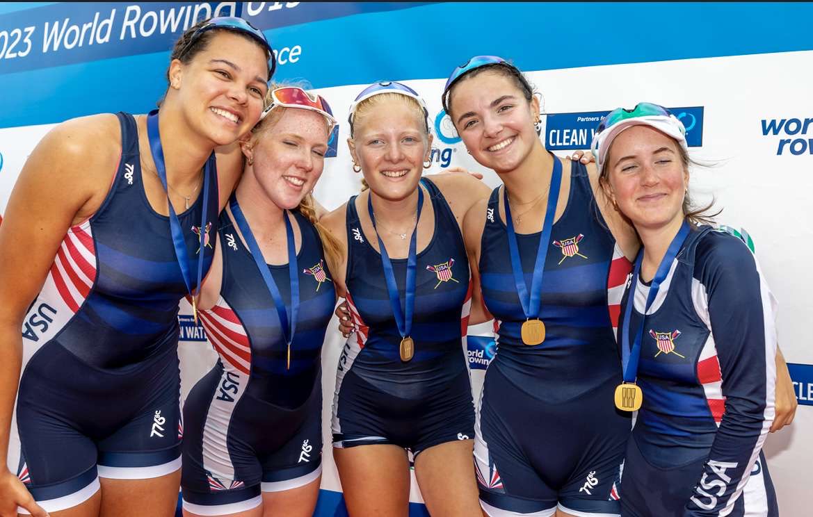 From left to right: Ella Wheeler, Becca Castelmach, Rosie Lundberg, Carly Brown ’24, Lucy Herrick. The crew celebrates their win in the Paris World Championship where they won gold. 