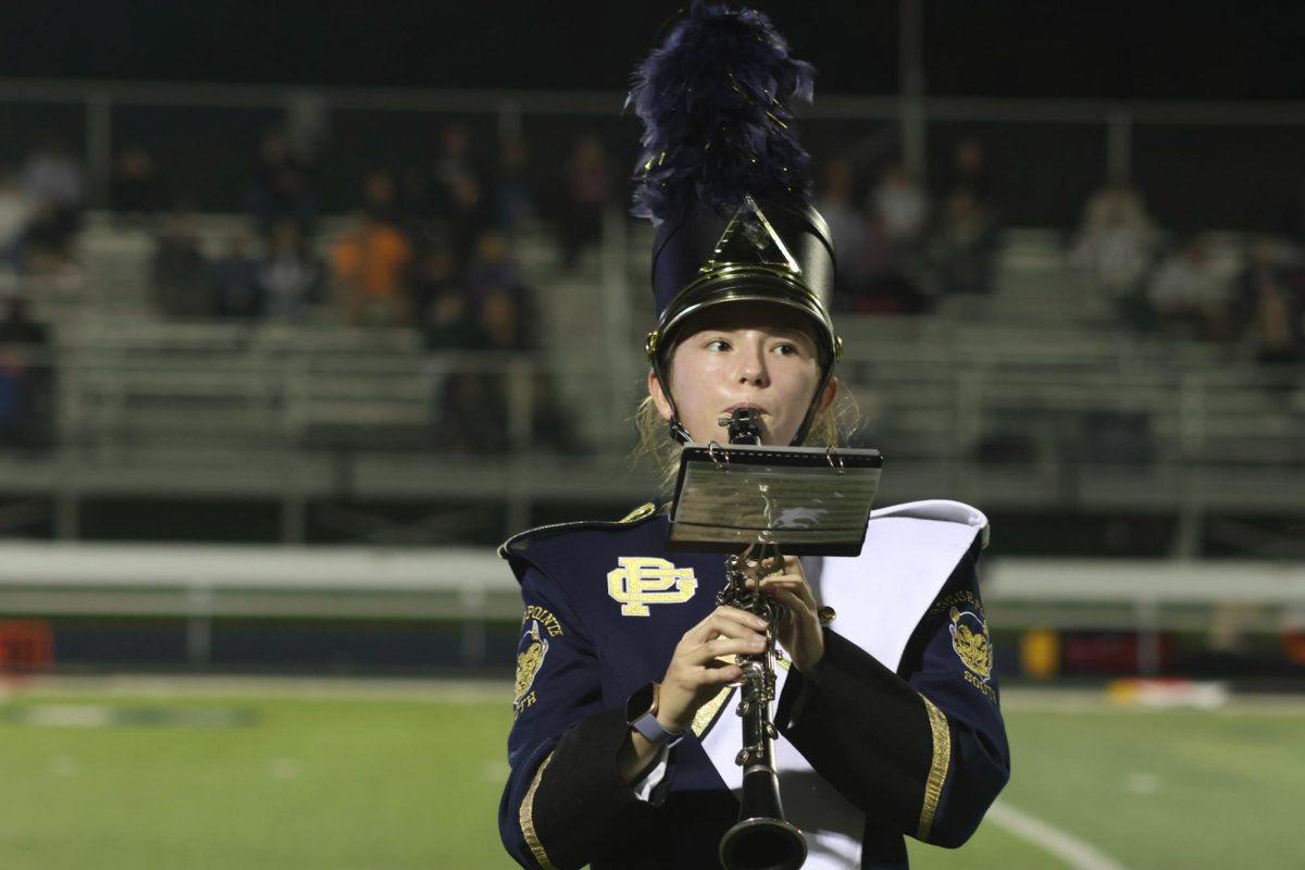 Clarinetist Chloe Spain ’27 plays her heart out at her first homecoming game on the marching band. 