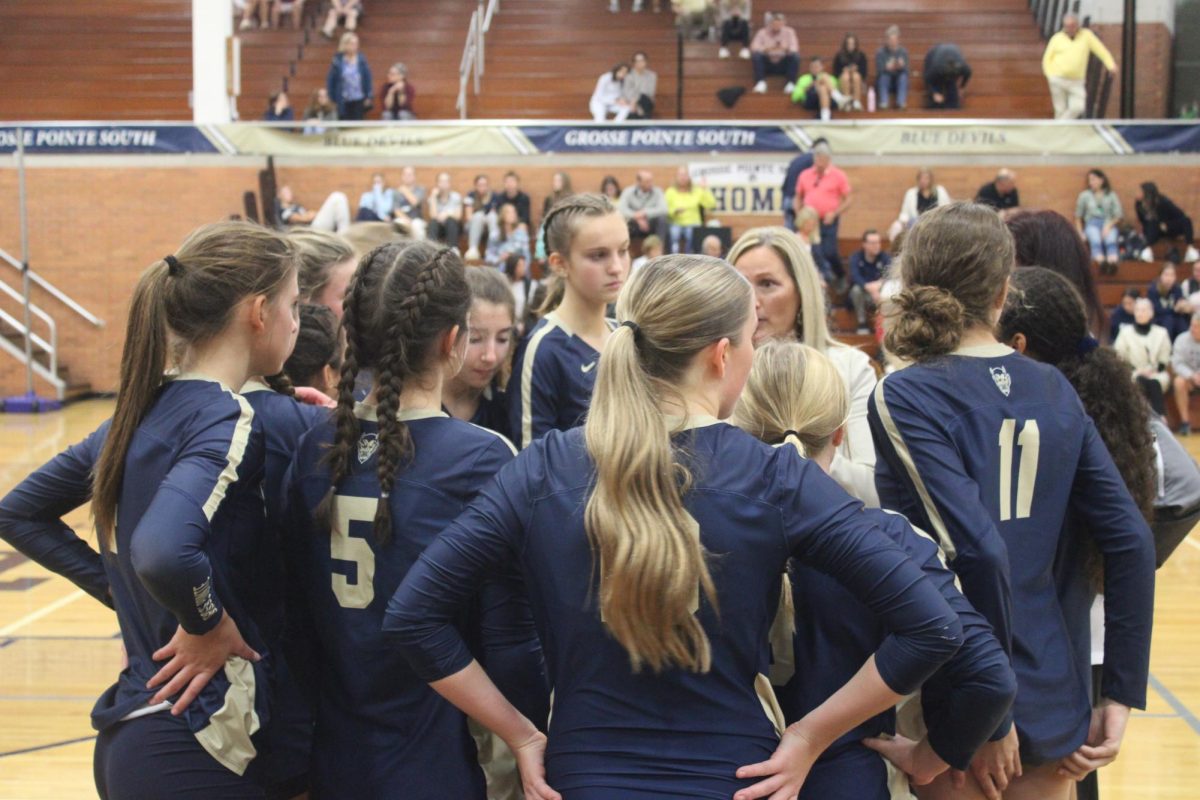 Following a discouraging loss in the second set, Janeil DiVita offers strategic advice and direction to push the players to get their momentum back. The following set, Grosse Pointe South won 25-21.