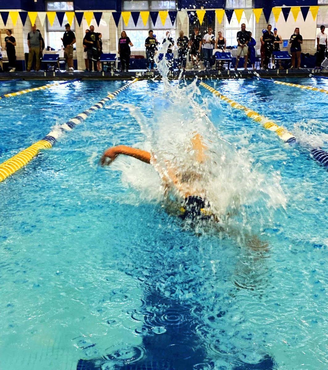 Ahead of the competition, Whitney Handwork ’26 is swimming in the 50-meter freestyle race.  After winning the MAC Red championship, she is shifting her focus to preparing for states.