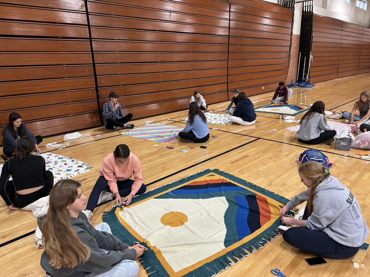 Members of the Interact Club come together with compassion and creativity as they embark on a heartwarming project—creating cozy blankets for those in need. With scissors in hand and a shared commitment to making a difference.