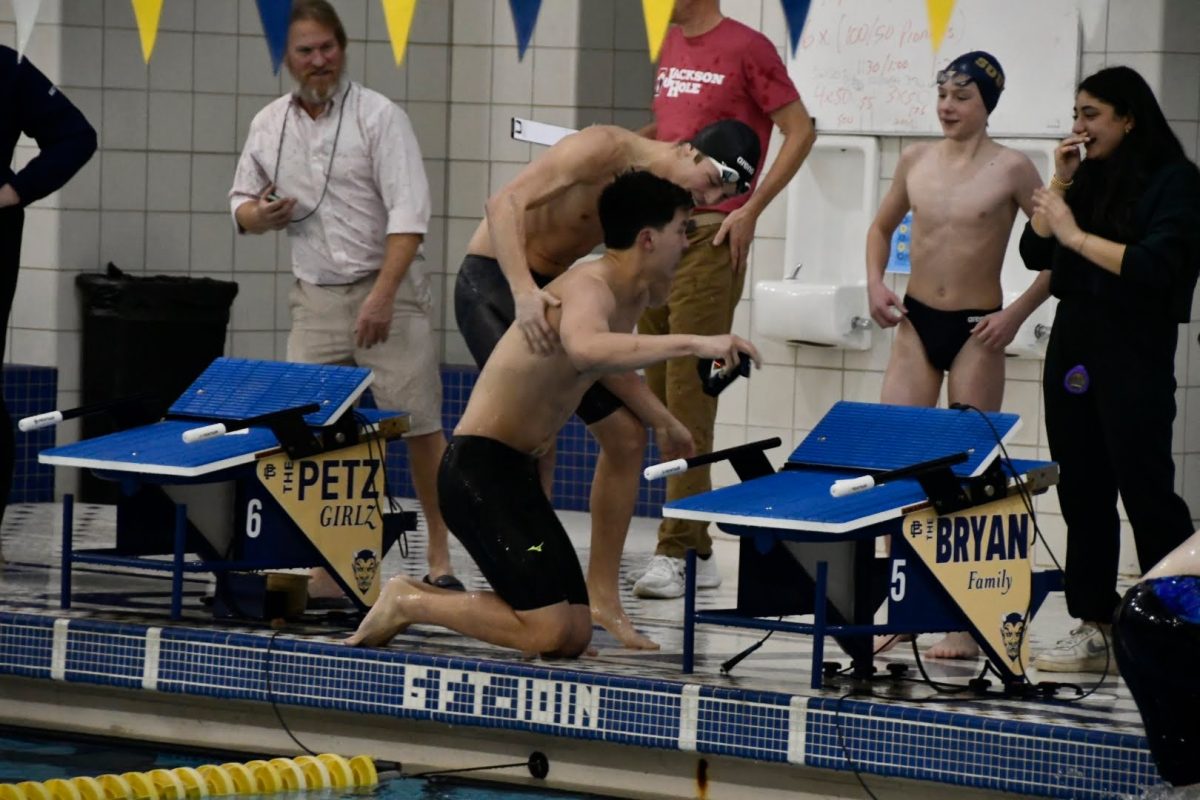 Captains Troy Liu 24 and Ben Bryan 24 supporting one another following an incredible 50 free by Liu.
