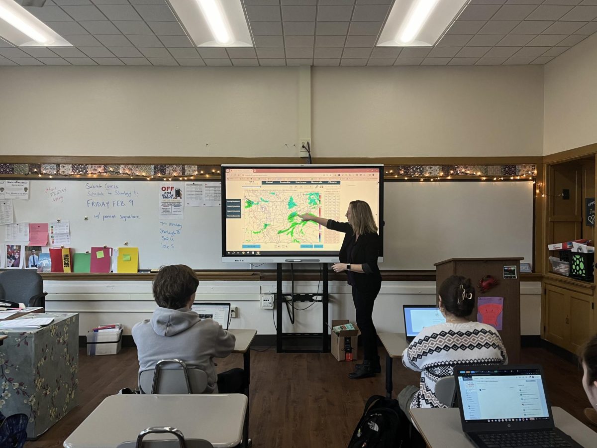 English teacher Sandra McCue shows a forecast model to her students illustrating average precipitation rates across the country.
