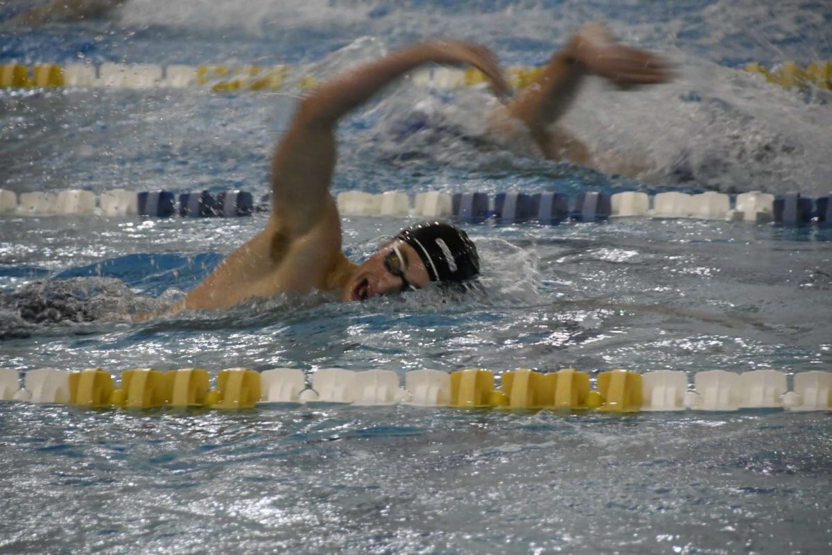 PURE PAIN Captain Ben Bryan ’24 leads his lane through a week of intense three-hour swim practices.