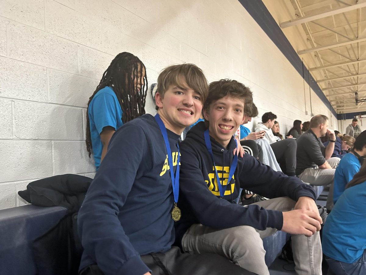 Jack Webber ‘24 and Shawn Coyle ‘24 sit in the stands waiting at the Science Olympiad tournament at Haslett High School.