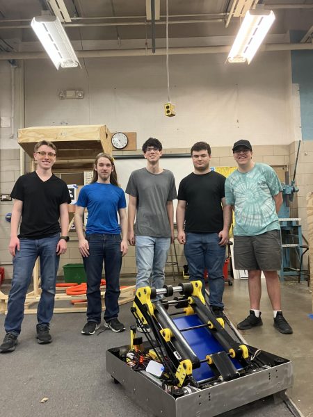 Grosse Pointe South Gearhead member Kaden Boismier-Buhr ’25, and Grosse Pointe North Gearhead members Drew Behringer ’25, Allan Cooney ’26, Gavin Perry ’26, and Michael Abood ’24 create their Robotic for the Woodhaven District competition from March 8-10. The team has been coding, building and testing their robotic, “Rinzler” for two months in preparation.