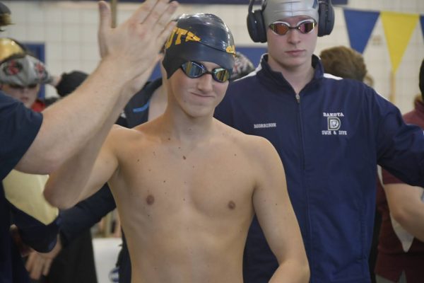 HEAD IN THE GAME Heading into the A final of the 100 breaststroke, Jack Finazzo ’25 gets a final boost of encouragement from his head coach. Crushing his best time, Finazzo placed sixth overall.
