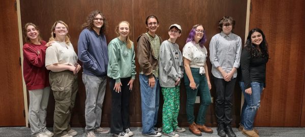 April 3rd Poetry Slam winners pose for a photo, pictured left to right are Stephanie Kosmas ‘24, Ghost Lindsay ‘25, Dagueneau Jewell ‘24,  Cecile Walsh ‘24, Josh Sonnenberg ‘25,Leo Ned’s-Fox ‘26, Elena Martin ‘26, Hermes Hermann ‘24, and Jules Kado ‘24.