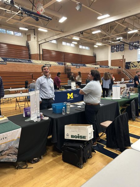 South High School Counselor Troy Glasser (left) takes advantage of College Night as he speaks with a representative from Northwood University (right) to better help students choose the right fit for them.