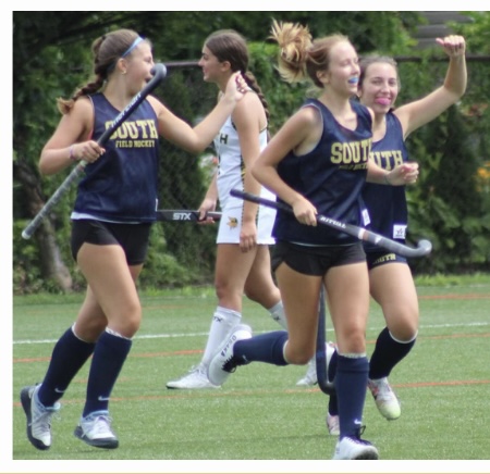 Sara Johnson ‘24, Bella Babcock ‘24, and Evelyn Young ‘24, share a victory together after scoring a goal against rivals, North High School.  
