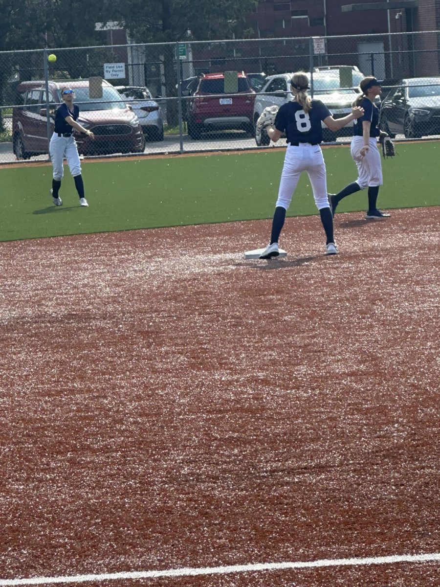 Kate_Kalmink_%E2%80%9927_covering_second_base_while_receiving_the_throw_from_center_fielder_Aubrey_Lindow_%E2%80%9927_off_of_a_base_hit_by_Regina.