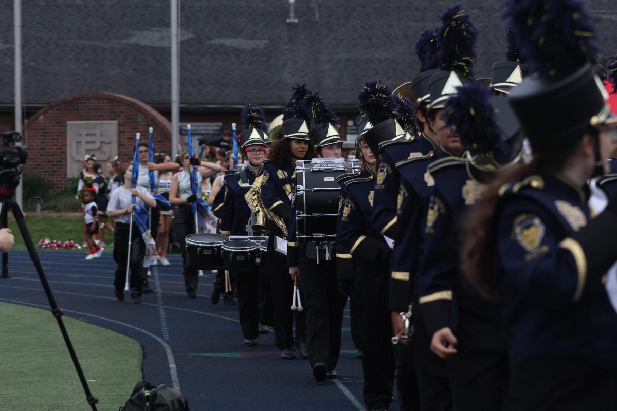 The Marching Band walks onto the field together before the 2024 homecoming football game.