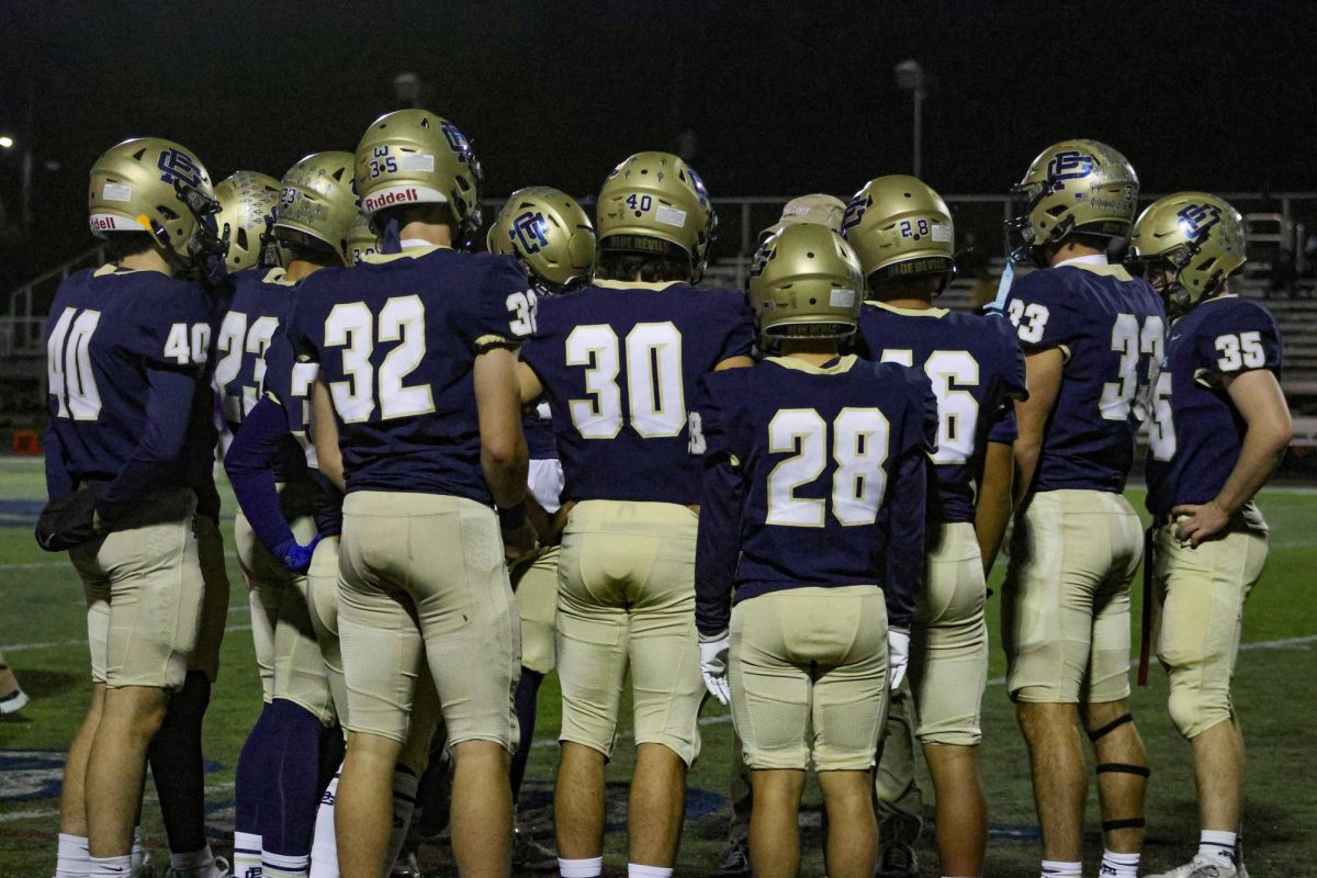 The kickoff team meets before the game to talk about their game plan.