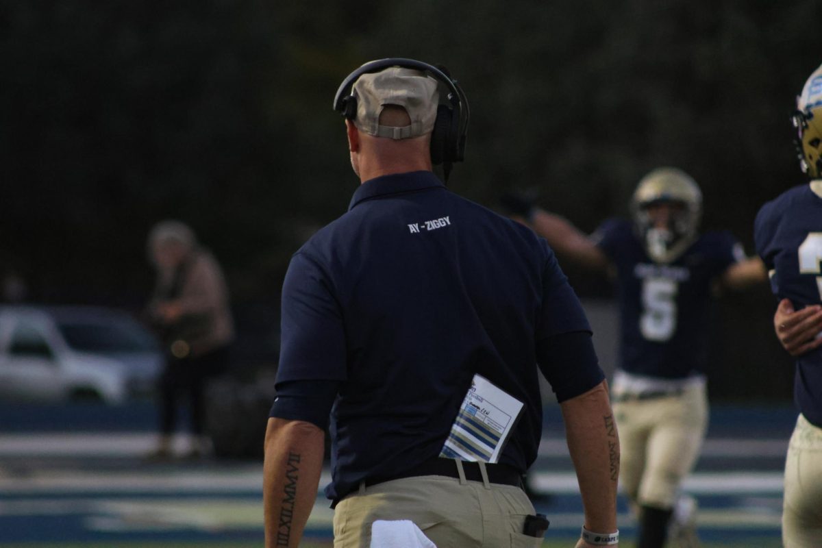 Coach Hepner advises his players after a good play.