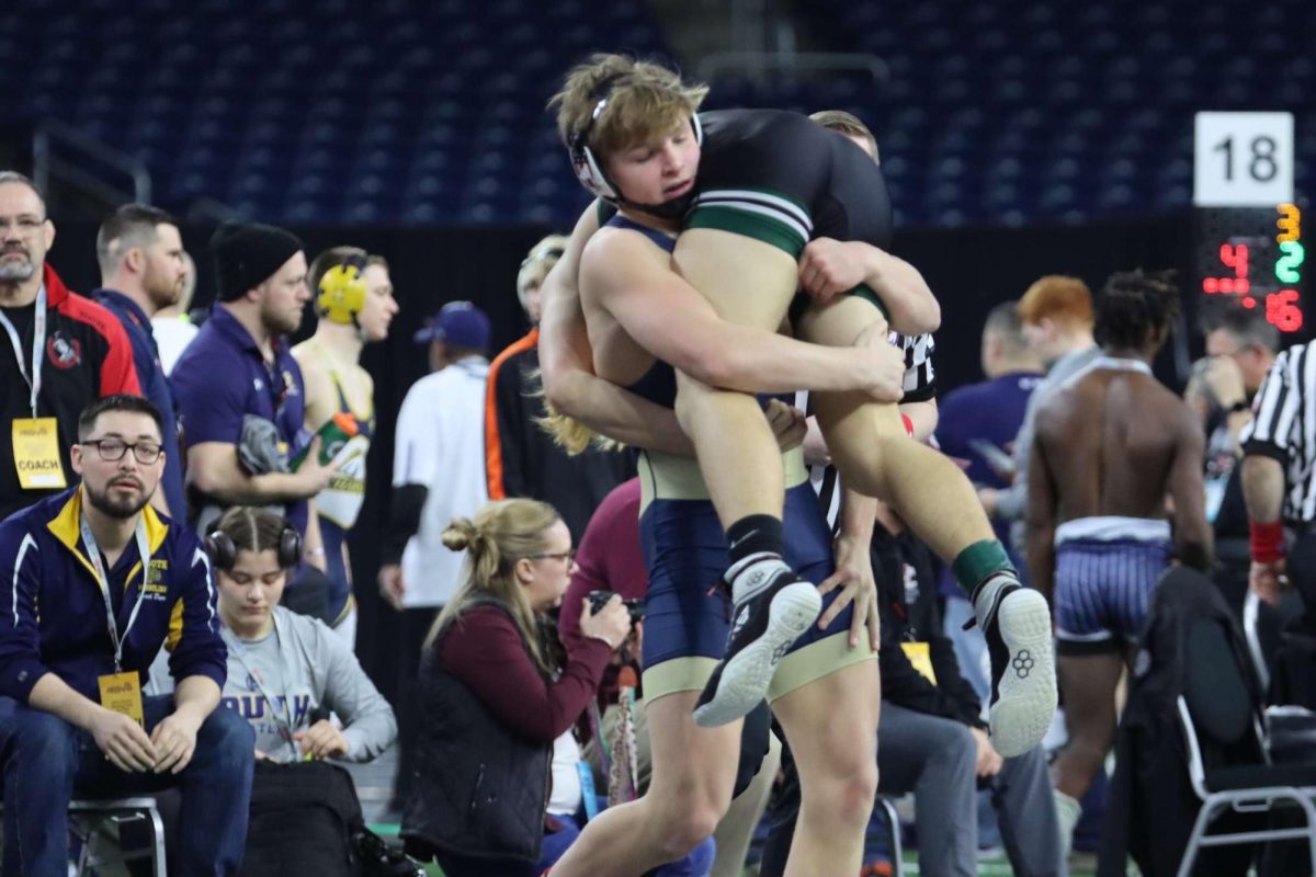 Wyatt Hepner ’25 takes down his opponent with a double-leg move during the state meet. 