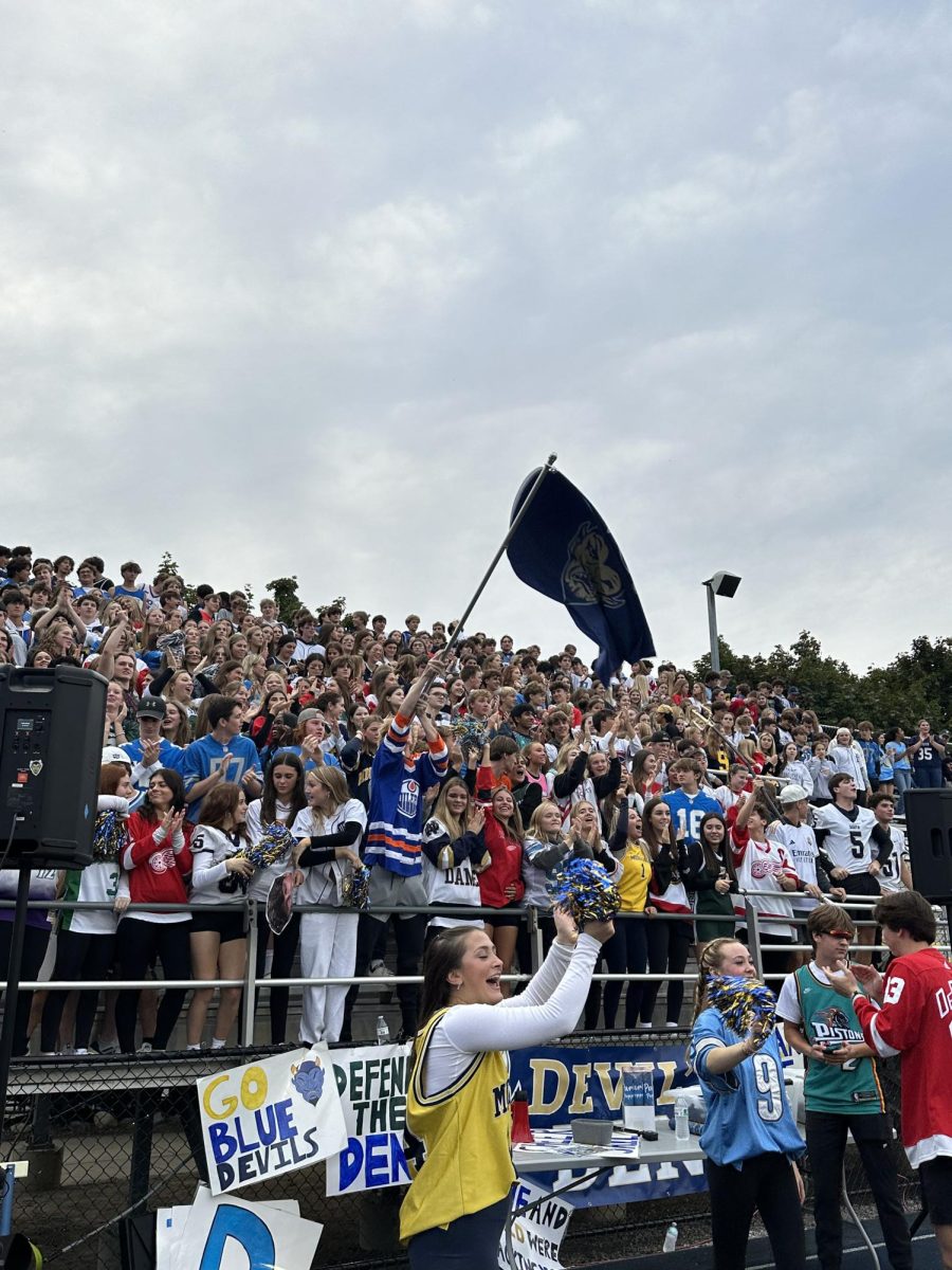 The students section pumped up after Grosse Pointe South touchdown.