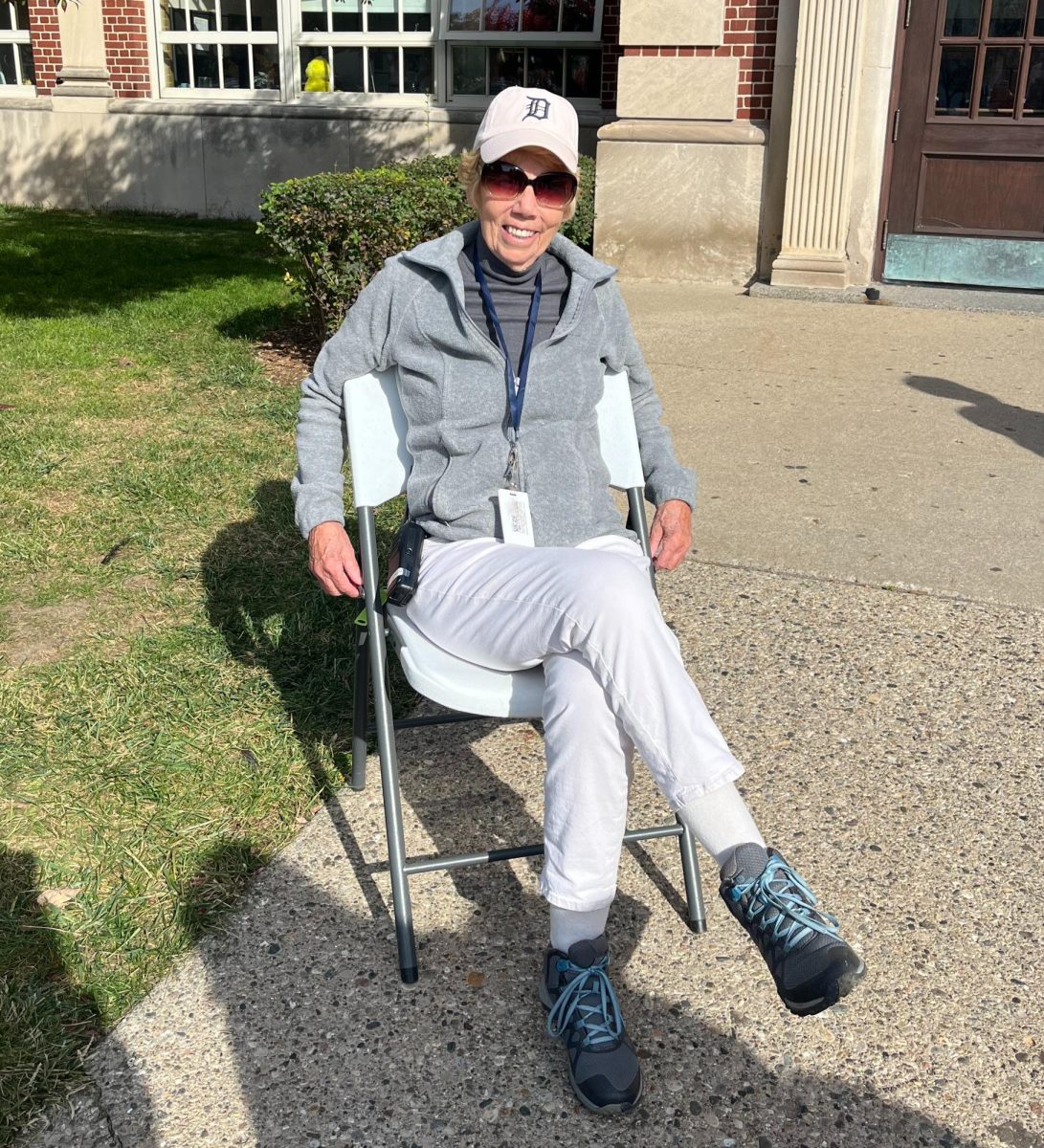 "Ms. Judy" as she is called by the students at South, poses in her chair that she sits in each lunch to welcome students and staff back to the building.