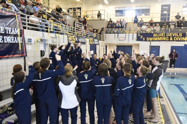 The girls swim team gathers together in camaraderie during a swim meet. (Photo courtesy of Jessica Bryan)