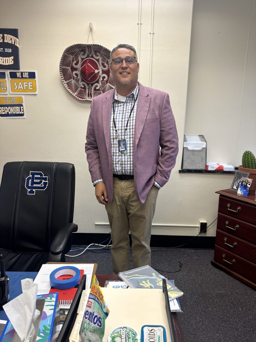 Dr. Hyliard stands smiling in his office, excited for new opportunities South has to offer.