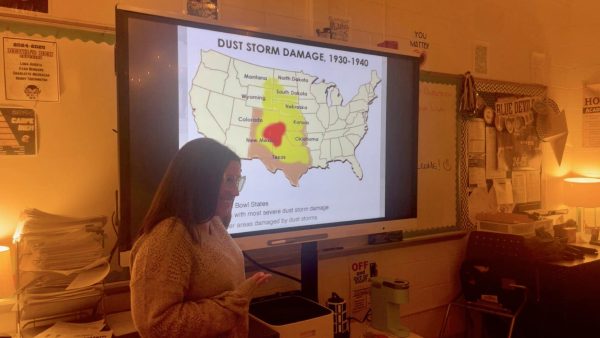 Mrs. Pierce teaching her U.S. History class about historical events in the past century. 