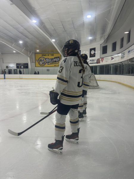 Anastazja Zieleniewski ’26 and the rest of the team line up for the national anthem before the first period starts.