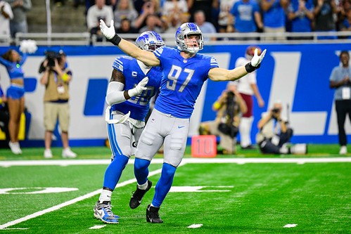 Aidan Hutchinson, the left defensive end for the Detroit Lions, displays excitement after making a play against the Washington Commanders.