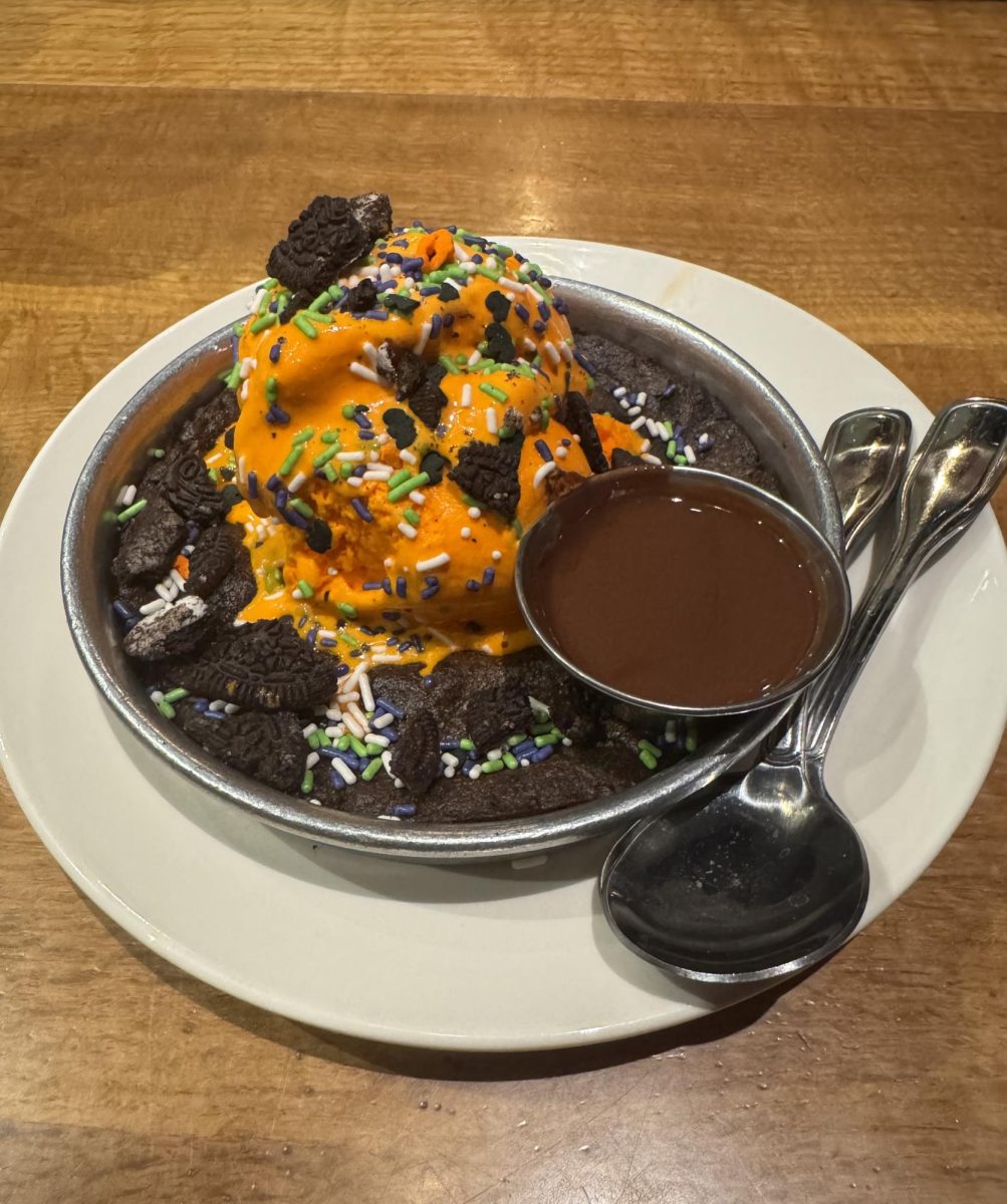 The Spookie Pizookie Cookies n Cream cookie dessert with Vanilla Bean ice cream on top and hard shell chocolate sauce on the side at BJ’s restaurant and brewhouse in Sterling Heights.