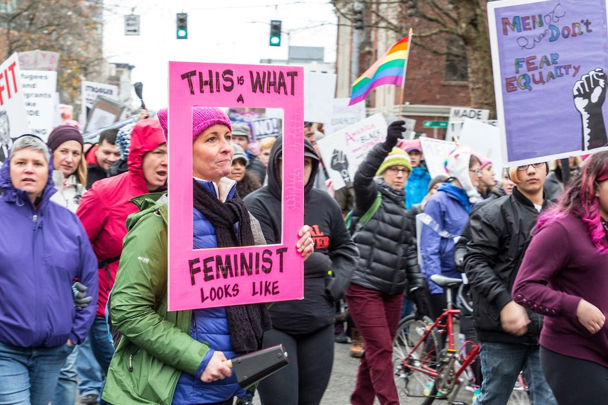 January 20, 2018 Seattle Washington Women March. Marchers hold up hand written protest signs. Photo courtesy of Cindy Shelby.