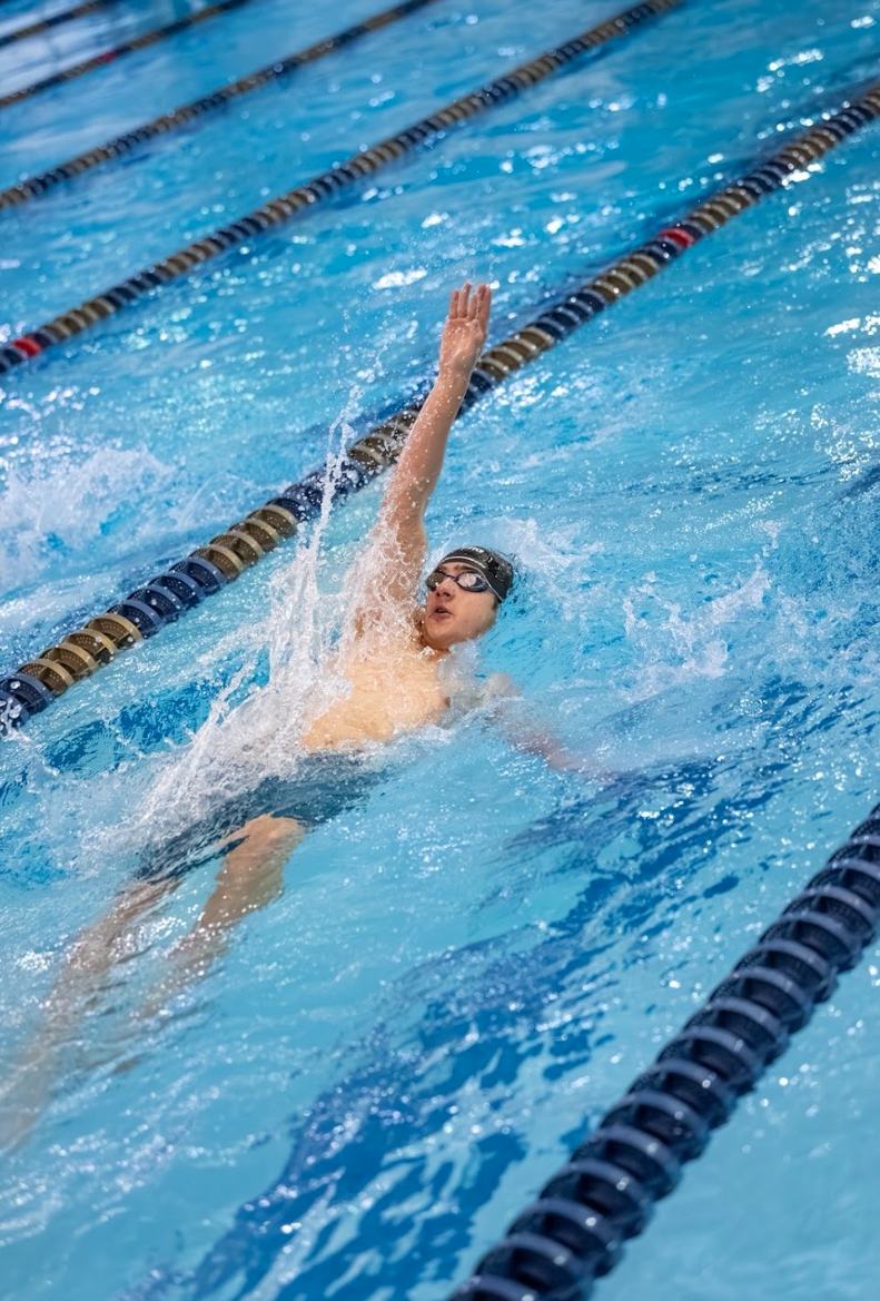 Oliver Ellefson ’27 swimming backstroke during the Macomb Area Conference championship. Ellefon’s placement helped Grosse Pointe South to secure their 28th championship title in a row.
Photo Courtesy: Grayson Wodzisz
