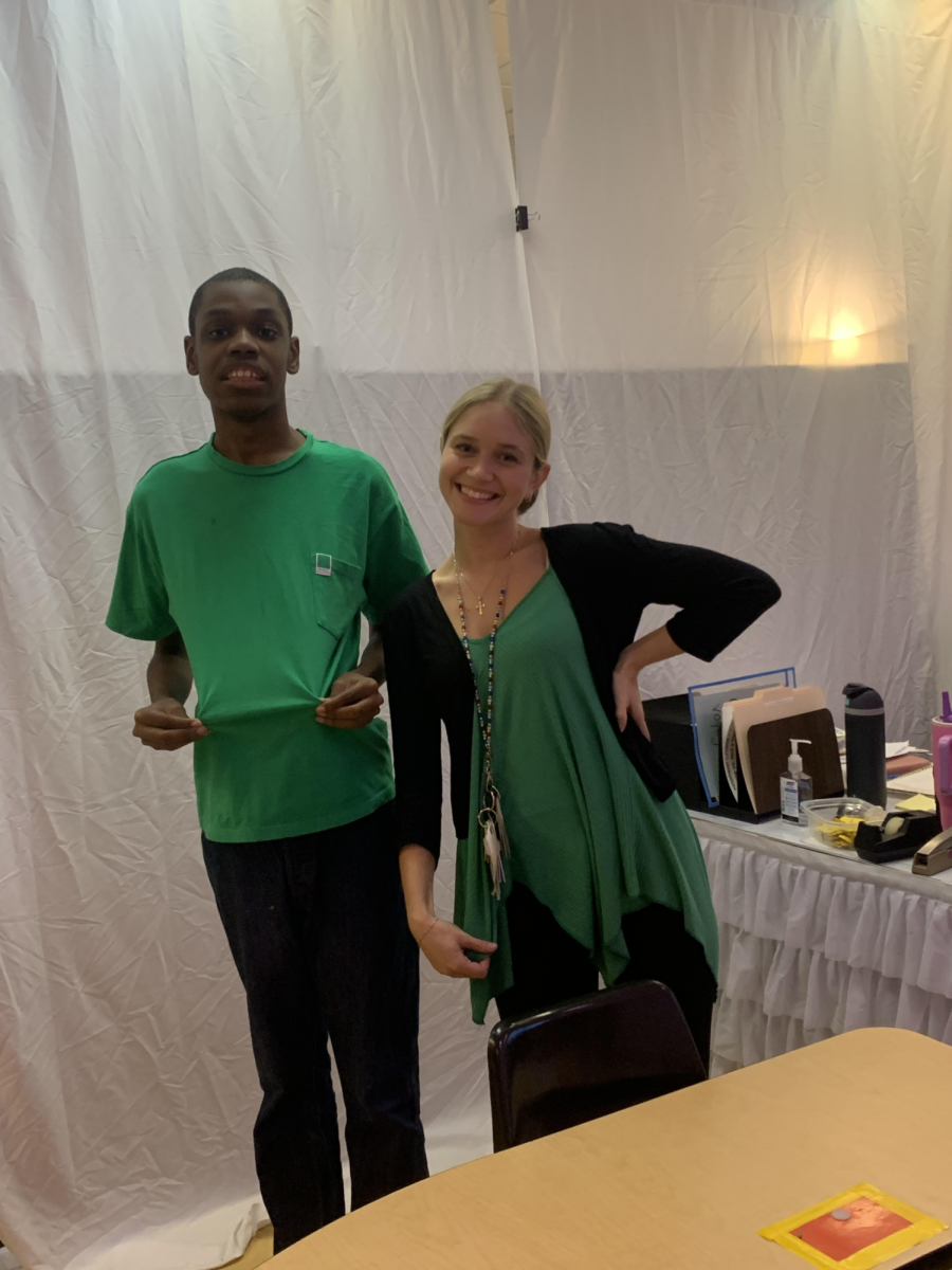 ASD teacher Anna-Mary Kloostra and student Benjamin Cooper ’28 pose for a picture after accidentally twinning with their matching green shirts. 