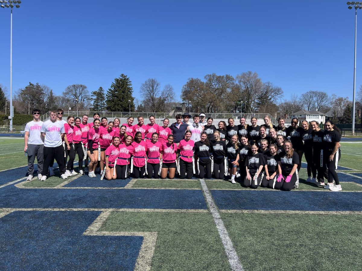 2025 Powderpuff Team: Participants of last year's team gather to take a group picture with coaches and the two teams (Pink: Seniors and Sophomores) against (Black: Juniors and Freshmen). The Senior and Sophomore team would beat the Juniors and Freshmen in a memorable match.  Photo courtesy of Meg Pierce.