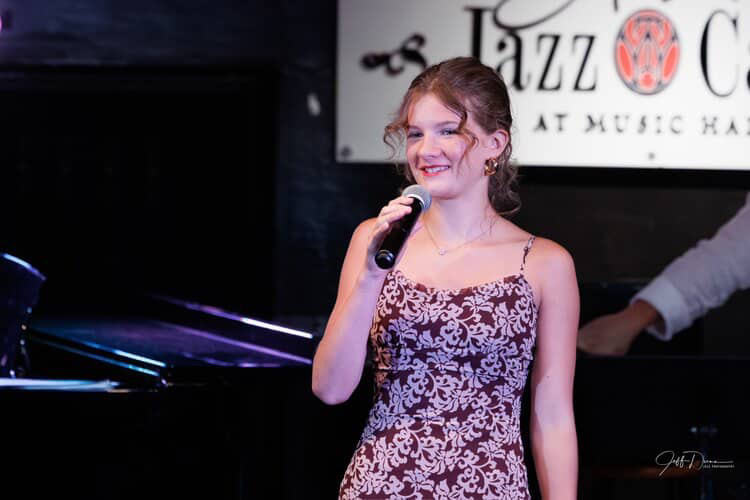 Tessa Wieczorek ’28 sings “Only a Paper Moon” by Ella Fitzgerald at Aretha’s Jazz Club in downtown Detroit. The performance was a part of a recital for their summer vocal jazz week, which helped Wieczorek develop her voice through the lens of jazz music. 
Photo Courtesy of Tessa Wieczorek.