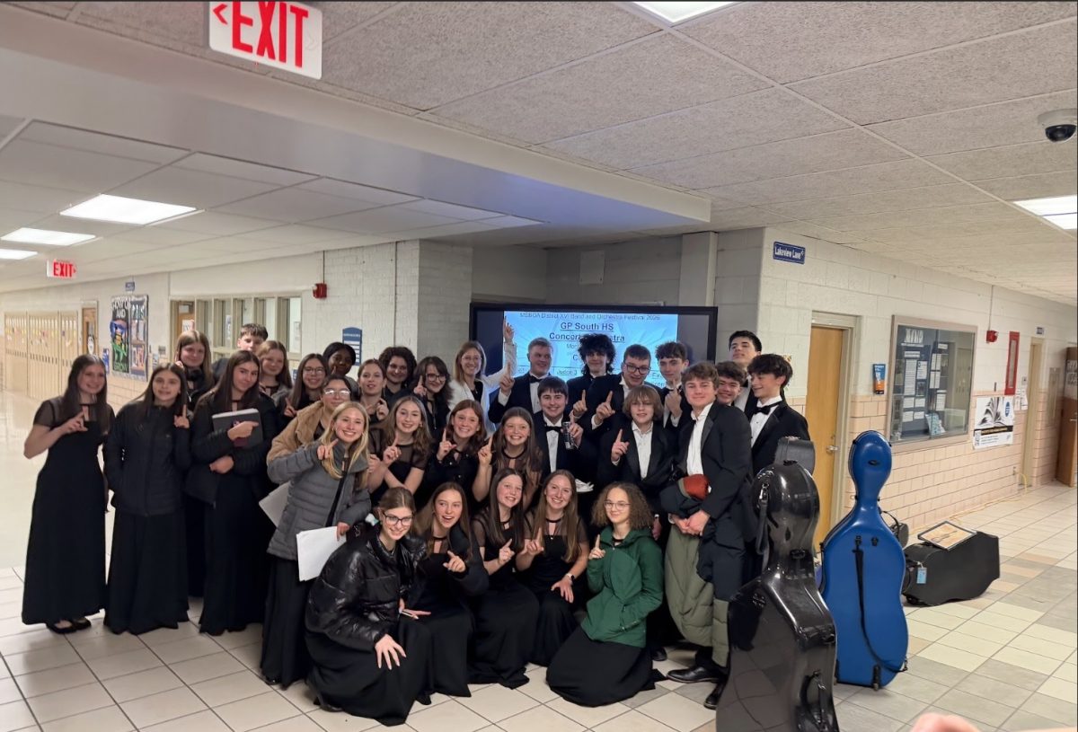Concert orchestra students gather for a group photo to commemorate their achievement after earning a Division One rating in every category during their MSBOA Festival performance.
