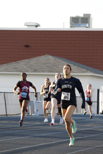 LEADING THE TRACK Morgan Duff runs the 200-meter dash as the South Girls’ track season opener against Warren Mott High School. Duff ran a 27.96, earning first place in the event. Photo courtesy of: Isabella Chaptini
